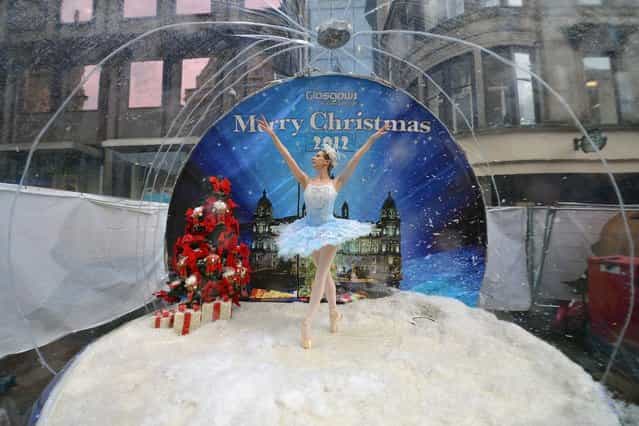 Claire Robertson from Scottish Ballet, poses dressed as the Good Snow Flake inside a life size snow globe on Buchanan Street during a promotion for Scottish Ballet's festive production of The Nutcracker on November 20, 2012 in Glasgow, Scotland. The Nutcracker opens at the Theatre Royal on December the 8th, the production delves deep into the darker reaches of Hoffmann's original tale in a fresh and vivid retelling of the famous Christmas story. (Photo by Jeff J. Mitchell)