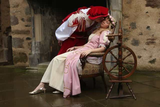 HOFGEISMAR, GERMANY - NOVEMBER 18: Prince Charming, actually actor Andreas Richhardt, kisses Sleeping Beauty, played by actress Elisabeth Knoche, to wake her from her 100-year sleep at Sababurg Palace on November 18, 2012 near Hofgeismar, Germany. Sleeping Beauty (in German: Dornroeschen) is one of the many stories featured in the collection of fairy tales collected by the Grimm brothers, and the 200th anniversary of the first publication of the stories will take place this coming December 20th. Andreas and Elisabeth perform a skit based on the Sleeping Beauty tale to visitors during the summer months at Sababurg, which is now a hotel called Dornroeschenschloss Sababurg and is located along the [Fairy Tale Road] ([Maerchenstrasse]) from where many of the tales derive. The Grimm brothers collected their stories from oral traditions in the region between Frankfurt and Bremen in the early 19th century, and the works include such global classics as Rapunzel, Little Red Riding Hood, The Pied Piper of Hamelin, Cinderella and Hansel and Gretel. (Photo by Sean Gallup)