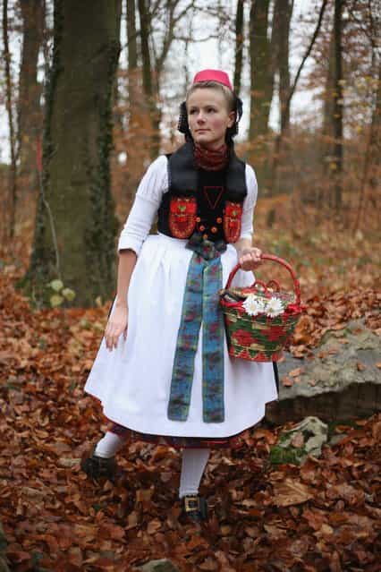 Little Red Riding Hood (in German: Rotkaeppchen, which translates to Little Red Cap), actually actress Dorothee Weppler, wears the local Schwalm region folk dress with its red cap as she walks through a forest on the estate of Baron von Schwaerzel on November 20, 2012 in Willingshausen, Germany. Little Red Riding Hood is one of the many stories featured in the collection of fairy tales collected by the Grimm brothers, and the two reportedly first came across the story while staying on the von Schwaerzel estate. The 200th anniversary of the first publication of Grimms' Fairy Tales will take place this coming December 20th. The Grimm brothers collected their stories from oral traditions in the region between Frankfurt and Bremen in the early 19th century, and the works include such global classics as Sleeping Beauty, Rapunzel, The Pied Piper of Hamelin, Cinderella and Hansel and Gretel. (Photo by Sean Gallup)