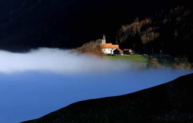 Fog covers a valley near Sachseln, Switzerland, November 16, 2012. (Photo by Urs Flueeler/Keystone)
