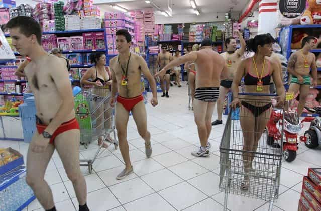 Customers in underwear shop during a special promotion at a mall in Ciudad del Este, Paraguay, on December 2, 2012. AFP PHOTO/ JOSE ESPINOLA (Photo credit should read JOSE ESPINOLA/AFP/Getty Images)