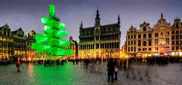 An abstract light installation replaces the traditional Christmas tree at the Grand Place in Brussels. Traditionally, a 65 ft. pine tree from the forests of the Ardennes decorates the city's central square, the Grand Place. This year, it has been replaced with an 82 ft. construction. (Photo by Geert Vanden Wijngaert/Associated Press)