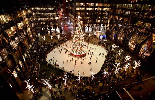 Skaters take to the ice around the Christmas tree at PPG Place on Light Up Night in downtown Pittsburgh. (Photo by Stephanie Strasburg/Tribune-Review)