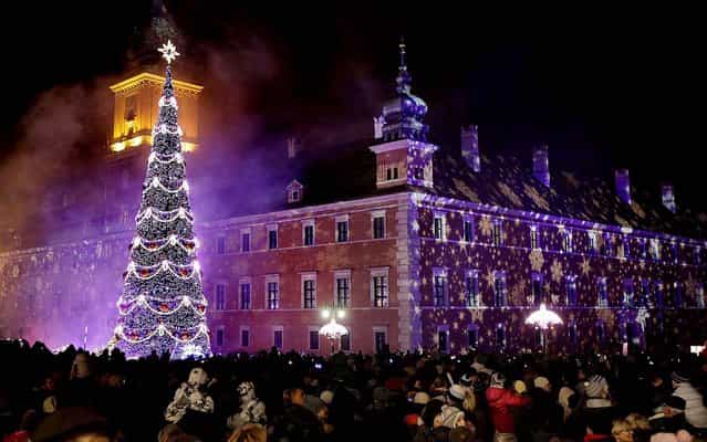 People enjoy Christmas illuminations on Royal Treaty Street in Warsaw, Poland. (Photo by Czarek Sokolowski/Associated Press)