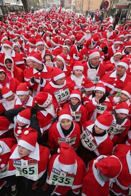 Participants dressed as Santa Claus gather shortly before the 4th annual Michendorf Santa Run (Michendorfer Nikolauslauf) on December 9, 2012 in Michendorf, Germany. Over 800 people took part in this year's races that included children's and adults' races. (Photo by Sean Gallup)