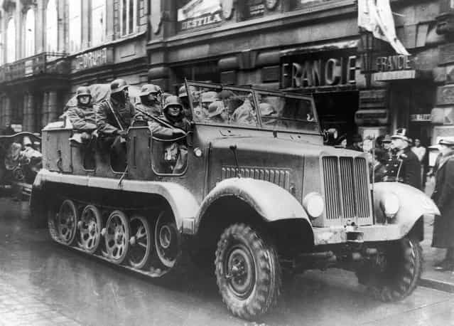 German troops in an armoured vehicle in one of Prague's main streets following the annexation of Sudetenland, 1939. (Photo by Keystone)