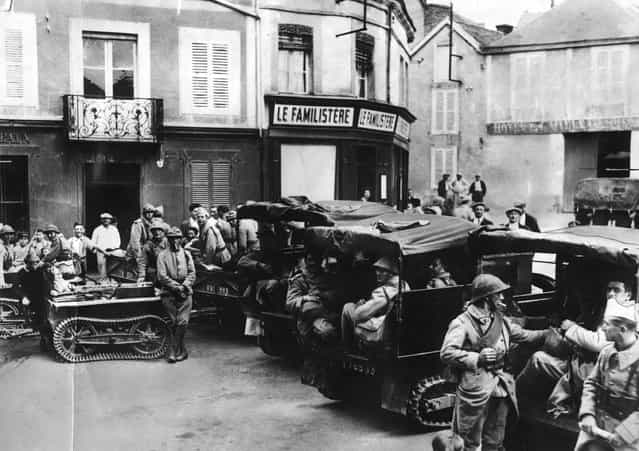 French jeeps with caterpillar treads towing mini tanks, stop at a French village, circa 1918. (Photo by Hulton Archive)