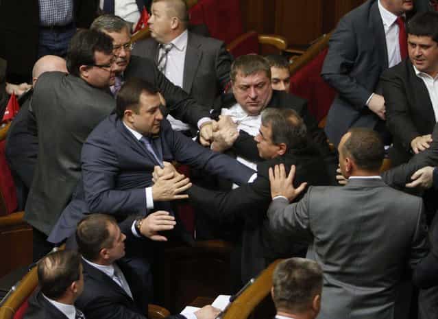 Parliament members scuffle over voting rules during the first session of the newly-elected Ukrainian parliament in Kiev. A session of Ukraine's new parliament collapsed amid chaos when brawls erupted among opposition deputies and those of the ruling party over the election of parliamentary officials. (Photo by Anatolii Stepanov/Reuters Photo)