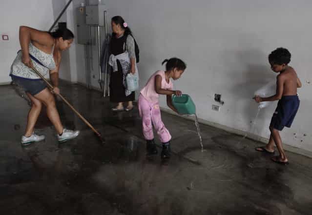 Members of Brazil's Movimento dos Sem-Teto (Roofless Movement) clean a vacant apartment they chose, in one of the 11 empty buildings that the movement took over in one night, in the centre of Sao Paulo, October 29, 2012. According to City Hall, there are some 400,000 people in need of stable housing, including the 4,000 families of the Roofless Movement who are squatting in abandoned or vacant buildings that range from apartment blocks to hotels, in Sao Paulo, the largest city in South America. (Photo by Nacho Doce/Reuters)