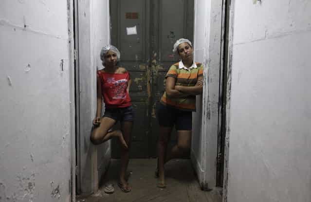 Members of Brazil's Movimento dos Sem-Teto (Roofless Movement) stand in the hallway of one of the 11 empty buildings that the movement took over recently, in the centre of Sao Paulo, November 6, 2012. According to City Hall, there are some 400,000 people in need of stable housing, including the 4,000 families of the Roofless Movement who are squatting in abandoned or vacant buildings that range from apartment blocks to hotels, in Sao Paulo, the largest city in South America. Picture taken November 6, 2012