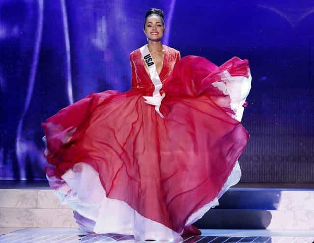 Miss USA, Olivia Culpo, walks on stage during a performance by Australian singer Timomatic. (Julie Jacobson/Associated Press)