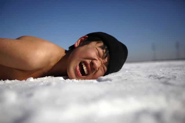 A student attending a winter military camp reacts during a training session in Ansan, south of Seoul January 3, 2013. Hundreds of students between 11 and 17 years old attend winter boot camp training courses every year. The winter courses range from 4 to 14 days at the Blue Dragon Camp run by retired marines, which also offers summer boot camp for students. REUTERS/Kim Hong-Ji (SOUTH KOREA - Tags: EDUCATION MILITARY SOCIETY)