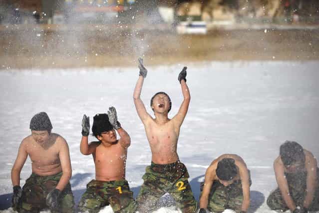 Students toss snow during a winter military camp in Ansan, south of Seoul January 3, 2013. Hundreds of students between 11 and 17 years old attend winter boot camp training courses every year. The winter courses range from 4 to 14 days at the Blue Dragon Camp run by retired marines, which also offers summer boot camp for students. REUTERS/Kim Hong-Ji (SOUTH KOREA - Tags: EDUCATION MILITARY SOCIETY)