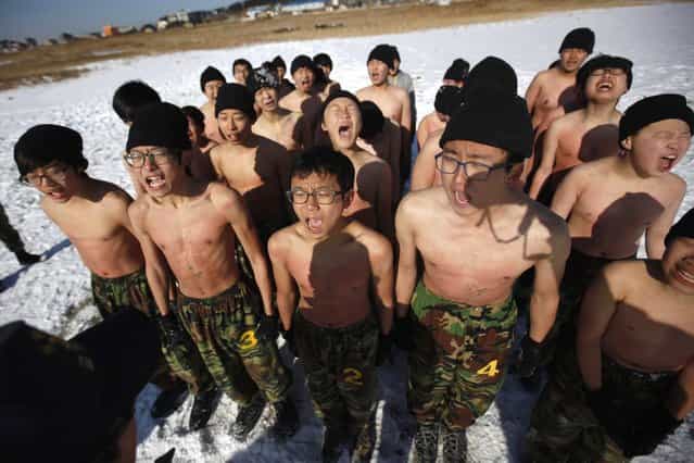 Students react while attending a winter military camp in Ansan, south of Seoul January 3, 2013. Hundreds of students between 11 and 17 years old attend winter boot camp training courses every year. The winter courses range from 4 to 14 days at the Blue Dragon Camp run by retired marines, which also offers summer boot camp for students. REUTERS/Kim Hong-Ji (SOUTH KOREA - Tags: EDUCATION MILITARY SOCIETY)