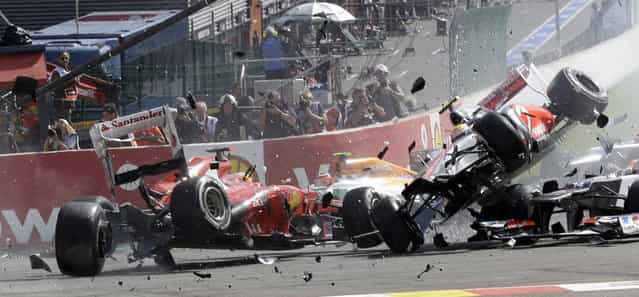 Ferrari driver Fernando Alonso of Spain, left, crashes with McLaren Mercedes driver Lewis Hamilton of Britain, airborne right, during the first lap of the Belgium Formula One Grand Prix in Spa-Francorchamps circuit, Belgium, Sunday, September 2, 2012. (Photo by Luca Bruno/AP Photo)