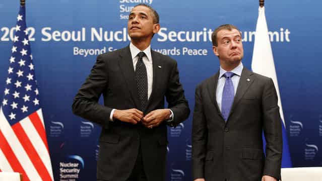 U.S. President Barack Obama, left, and Russian President Dmitry Medvedev stand together at the end of a bilateral meeting at the Nuclear Security Summit in Seoul, South Korea, March 26, 2012. (Photo by Pablo Martinez Monsivais/AP Photo)