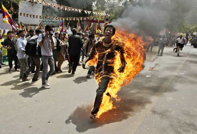In this March 26, 2012 file photo, Tibetan exile Jamphel Yeshi screams as he runs engulfed in flames after setting himself on fire at a protest in New Delhi, India, against Chinese President Hu Jintao's visit to India. Yeshi died Wednesday, March 28, 2012. (Photo by Manish Swarup/AP Photo)
