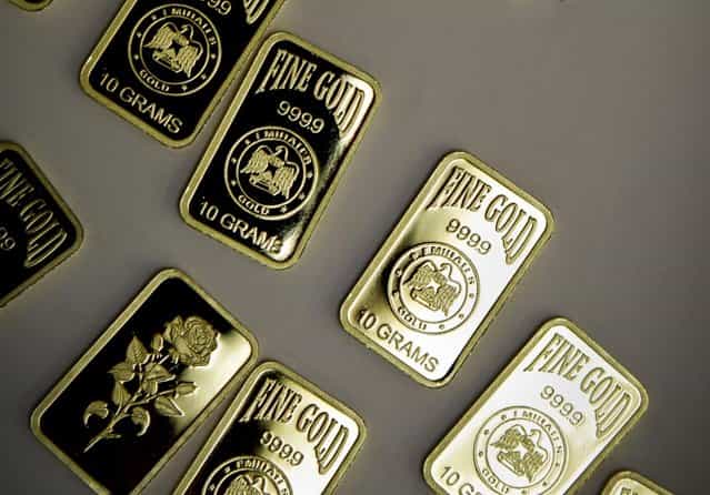 10 gram gold bars with a purity of 999.9 have been pressed and stamped with the «Emirates Gold» company logo in Dubai, United Arab Emirates. Dubai now has about a 29 percent market share of global gold trade with nearly 1,200 tons – worth about $41 billion – changing hands annually at the city's gold markets, according to the gold industry website bullionstreet.com. (Photo by Kamran Jebreili/AP Photo)