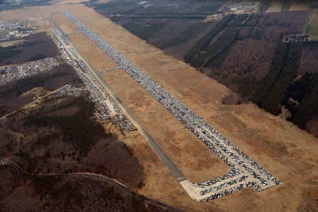 Tens of thousands of vehicles damaged by super storm Sandy are being temporarily stored on runways and taxiways at Calverton Executive Airpark in Calverton, New York, on January 9, 2013. (Photo by Stan Honda/AFP Photo)