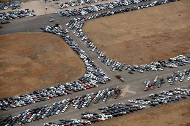 Tens of thousands of vehicles damaged by super storm Sandy are being temporarily stored on runways and taxiways at Calverton Executive Airpark in Calverton, New York, on January 9, 2013 in this aerial view. Insurance Auto Auctions Inc, a salvage auto auction company specializing in total-loss vehicles, acquired the cars and trucks that were damaged, destroyed or flooded by the storm and needed a place to store them. The company made a deal with the Town of Riverhead to lease the airport land and then the vehicles are auctioned online. AFP PHOTO/Stan HONDA