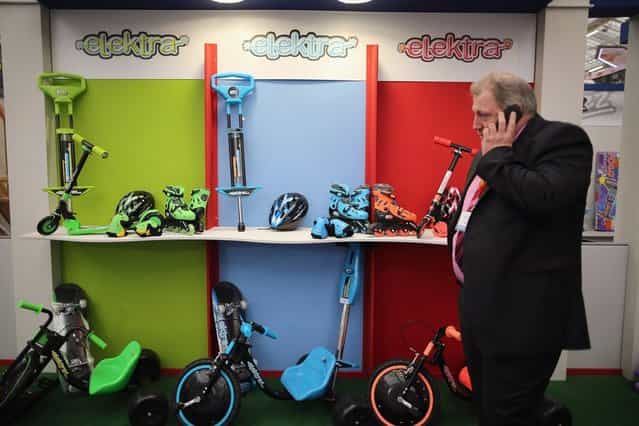 A man walks past a trade stand during the 2013 London Toy Fair at Olympia Exhibition Centre on January 22, 2013 in London, England. The annual fair which is organised by the British Toy and Hobby Association, brings together toy manufacturers and retailers from around the world. (Photo by Dan Kitwood)