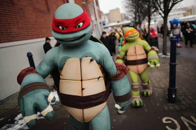 Life size Teenage Mutant Ninja Turtles cartoon characters are led outside for a photocall during the 2013 London Toy Fair at Olympia Exhibition Centre on January 22, 2013 in London, England. The annual fair which is organised by the British Toy and Hobby Association, brings together toy manufacturers and retailers from around the world. (Photo by Dan Kitwood)