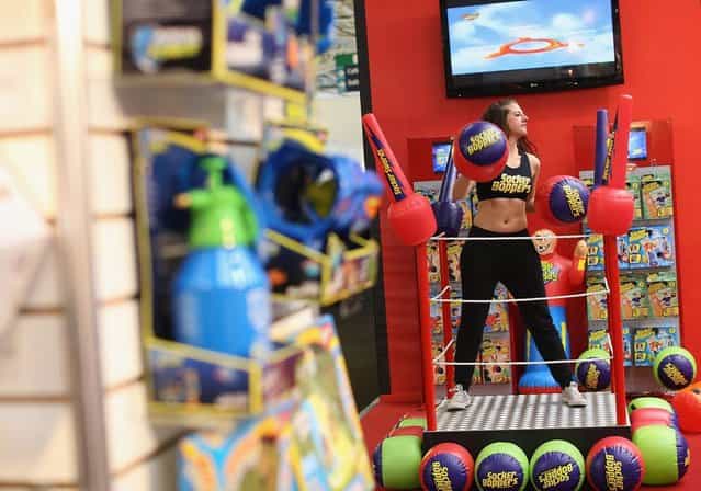 A woman works out on a trade stand during the 2013 London Toy Fair at Olympia Exhibition Centre on January 22, 2013 in London, England. The annual fair which is organised by the British Toy and Hobby Association, brings together toy manufacturers and retailers from around the world. (Photo by Dan Kitwood)
