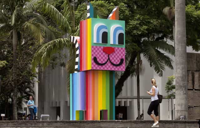 A cat-shaped wooden sculpture designed by Brazilian street artist Minhau greets visitors just outside the Brazilian Museum of Sculpture, MuBE, marking the second edition of the International Graffiti Fine Art Biennial, in Sao Paulo, Brazil, Tuesday, January 22, 2013. The event runs from January 22 – February 24 and features work of more than 50 street artists, representing 11 countries. (Photo by Andre Penner/AP Photo)