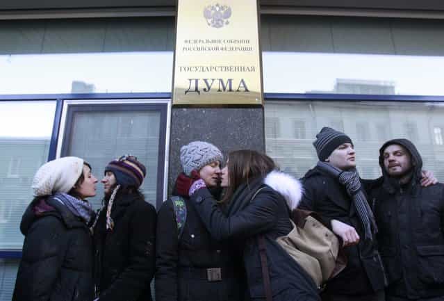 Gay rights supporters kiss each other during a protest outside of Russian Parliament lower in downtown Moscow, on January 22, 2013. A federal law banning homosexual propaganda was submitted to lawmakers late last year. (Photo by Ivan Sekretarev/Associated Press)
