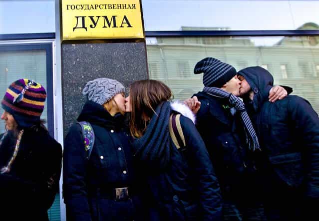 Gay rights supporters kiss each other during a protest outside of Russian Parliament lower in downtown Moscow, on January 22, 2013. A federal law banning homosexual propaganda was submitted to lawmakers late last year. (Photo by Ivan Sekretarev/Associated Press)