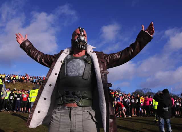 A competitor dressed as [Bain] from the Batman films poses before the Tough Guy Challenge endurance race on January 27, 2013 in Telford, England. Every year thousands of people run the 8 mile assault course which involves freezing temperatures, fire and ice. (Photo by Michael Regan)