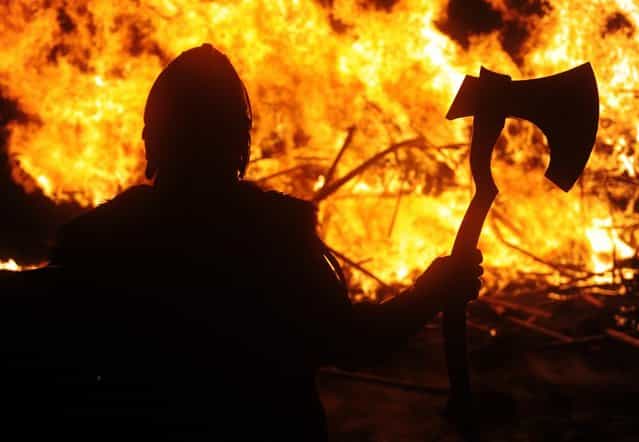 Members of the 2013 'Jarl Squad' prepare for the annual Up Helly Aa festival which culminates in the burning of a Viking Galley in Lerwick, Shetland Islands on January 29, 2013. Up Helly Aa celebrates the influence of the Scandinavian Vikings in the Shetland Islands and culminates with up to 1,000 'guizers' (men in costume) throwing flaming torches into their Viking longboat and setting it alight later in the evening. AFP PHOTO / ANDY BUCHANAN (Photo credit should read Andy Buchanan/AFP/Getty Images)