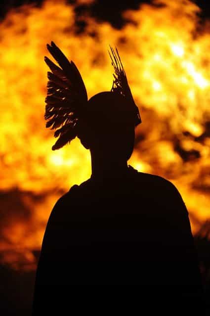 Members of the 2013 'Jarl Squad' prepare for the annual Up Helly Aa festival which culminates in the burning of a Viking Galley in Lerwick, Shetland Islands on January 29, 2013. Up Helly Aa celebrates the influence of the Scandinavian Vikings in the Shetland Islands and culminates with up to 1,000 'guizers' (men in costume) throwing flaming torches into their Viking longboat and setting it alight later in the evening. AFP PHOTO / ANDY BUCHANAN (Photo credit should read Andy Buchanan/AFP/Getty Images)