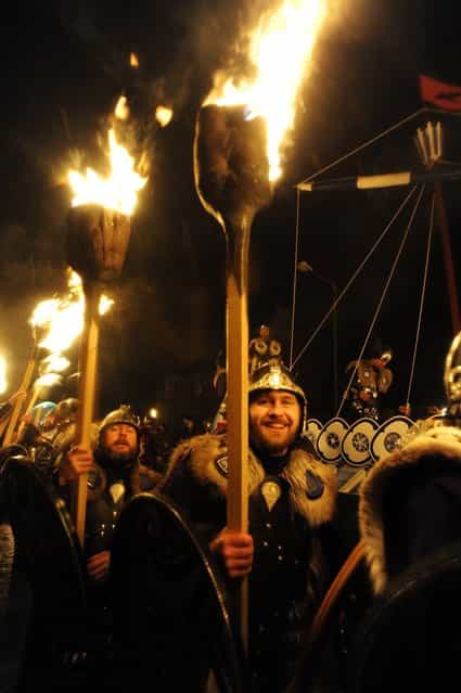 Members of the 2013 'Jarl Squad' take part in the annual Up Helly Aa festival which culminates in the burning of a Viking Galley in Lerwick, Shetland Islands on January 29, 2013. Up Helly Aa celebrates the influence of the Scandinavian Vikings in the Shetland Islands and has employed this theme in the festival since 1870. The event culminates with up to 1,000 'guizers' (men in costume) throwing flaming torches into their Viking longboat. AFP PHOTO / ANDY BUCHANAN (Photo credit should read Andy Buchanan/AFP/Getty Images)