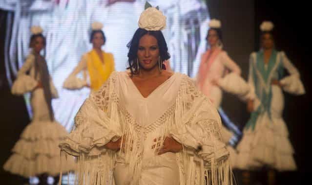 A model wears a creation by Spanish designer Pilar Vera during the International Flamenco Fashion Show in Seville, Spain on Saturday, February 2, 2013. (Photo by Miguel Angel Morenatti/AP Photo)