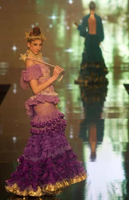 A model wears a creation by Spanish designer Rosalia Zahino during the International Flamenco Fashion Show in Seville, Spain on Saturday, February 2, 2013. (Photo by Miguel Angel Morenatti/AP Photo)
