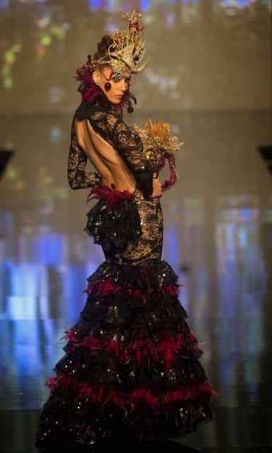 A model wears a creation by Spanish designer Rosalia Zahino during the International Flamenco Fashion Show in Seville, Spain on Saturday, February 2, 2013. (Photo by Miguel Angel Morenatti/AP Photo)