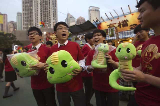 Shop assistants hold stuffed snake toys ahead of Lunar New Year celebrations at Victoria Park in Hong Kong February 4, 2013. The Lunar New Year, also known as the Spring Festival, begins on February 10 and marks the start of the Year of the Snake, according to the Chinese zodiac. Picture taken February 4, 2013. (Photo by Tyrone Siu/Reuters)