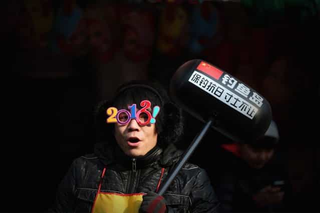 A vendor shows the toy of hammer with Chinese characters 'Defend the Diaoyu Islands ' at the Spring Festival Temple Fair for celebrating Chinese Lunar New Year of Snake at the Temple of Earth park on February 9, 2013 in Beijing, China. The Chinese Lunar New Year of Snake also known as the Spring Festival, which is based on the Lunisolar Chinese calendar, is celebrated from the first day of the first month of the lunar year and ends with Lantern Festival on the Fifteenth day. (Photo by Feng Li)
