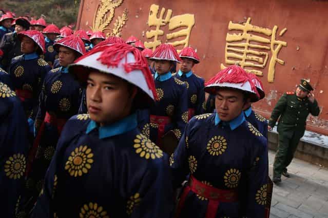 Chinese paramilitary police officers dressed as Qing Dynasty servants before a re-enactment of an ancient ceremony of Qing Dynasty emperors praying for good harvest and fortune during the opening ceremony of the Spring Festival Temple Fair at the Temple of Earth park on February 9, 2013 in Beijing, China. The Chinese Lunar New Year of Snake also known as the Spring Festival, which is based on the Lunisolar Chinese calendar, is celebrated from the first day of the first month of the lunar year and ends with Lantern Festival on the Fifteenth day. (Photo by Feng Li)