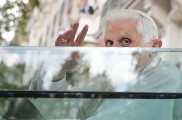 Pope Benedict XVI waves from the popemobile on his way for an evening prayer service at Notre Dame Cathedral on September 12, 2008 in Paris during his first visit to France. Pope Benedict XVI announced on February 11, 2013 he will resign on February 28, the first pontiff to step down in centuries. (Photo by Olivier Laban-Mattei/AFP Photo)
