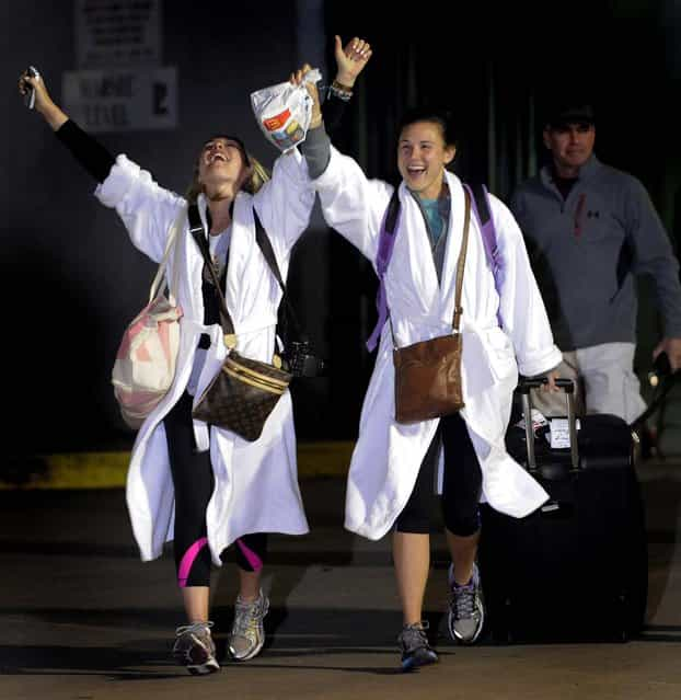 Kendall Jenkins, left, celebrates with a friend after getting off the Carnival Triumph in Mobile, Alabama, February 14, 2013. The ship with more than 4,200 passengers and crew members has been idled for nearly a week in the Gulf of Mexico following an engine room fire. (Photo by John David Mercer/Associated Press)