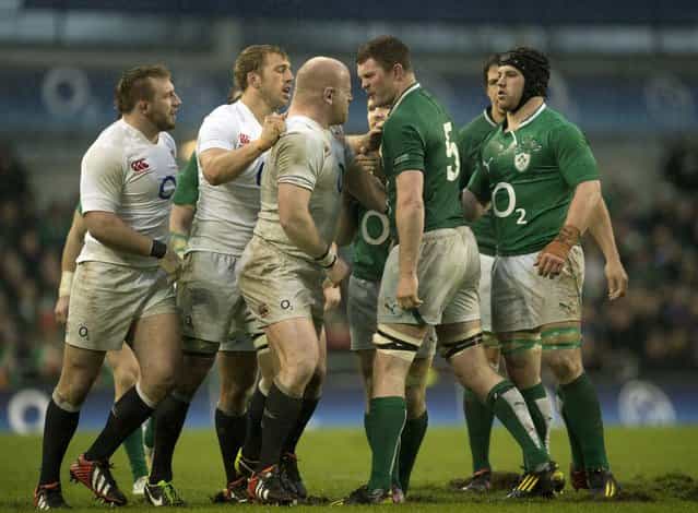 England's prop Dan Cole (3L) goes head to head with Ireland's lock Donnacha Ryan (2R) during the Six Nations international rugby union match between Ireland and England at the Aviva Stadium in Dublin on February 10, 2013. England won the game 12-6. (Photo by Adrian Dennis/AFP Photo)
