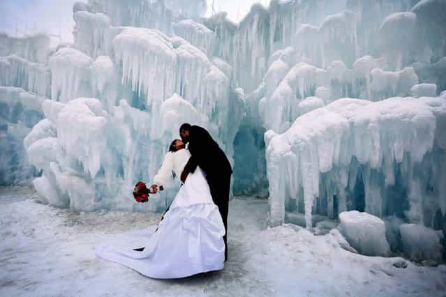 Brandon and Natasha Green, of Minneapolis, give each other a smooch after a ceremony during which eleven couples were married in a ceremony at the Mall of America Ice Castle in Bloomington, Minnesota, on February 14, 2013. (Photo by Brian Peterson/Minneapolis Star Tribune/MCT)