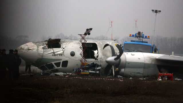 Ukrainian AN-24 plane is seen after crash outside an airport in the eastern Ukrainian city of Donetsk, Thursday, February 14, 2013. The plane carrying soccer fans headed for a match between Ukraine's Shakhtar and Borussia Dortmund, skidded past the landing strip and overturned, killing five people. The plane was carrying 44 people from the Black Sea port of Odessa. (Photo by Irina Gorbaseva/Associated Press)