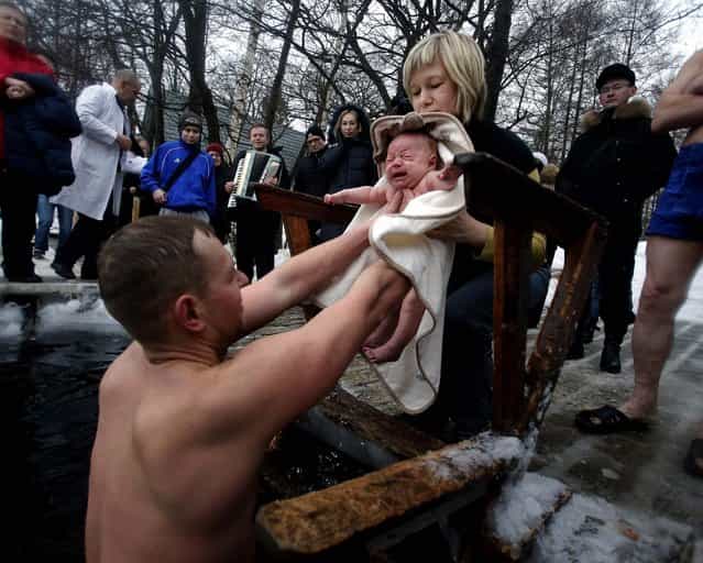 Aleksander and Anna prepare to bathe their two month old son Viktor during an ice swimmer's event in St.Petersburg, Russia, where the temperature is around 27 F (–3 °C), on February 10, 2013. (Dmitry Lovetsky/Associated Press)