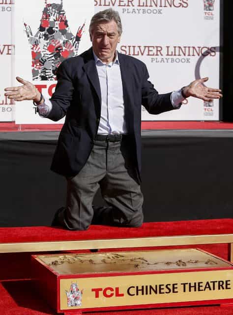 US actor Robert De Niro shows off his hands after making an imprint in cement during a ceremony at the TCL Chinese Theatre in Hollywood, California USA, 04 February 2013. De Niro, a two time Academy Award winner is currently nominated for an Academy Award for [Best Supporting Actor] for his role in the film Silver Linings Playbook. (Photo by Bret Hartman/EPA)