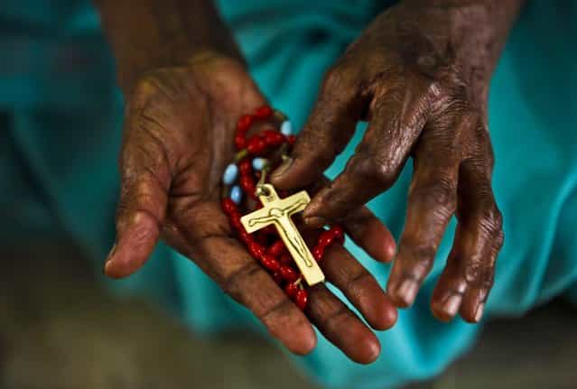 A woman holds a rosary and prays on Ash Wednesday at Saint Mary's Basilica in Hyderabad, India, on February 13, 2013.(Photo by Mahesh Kumar A./Associated Press)