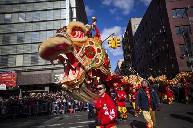 Dragon dancers cross Canal Street during the 14th Annual Chinatown Lunar New Year parade on February 17, 2013 in New York City. This year celebrates the Year of the Snake. (Photo by Michael Nagle)