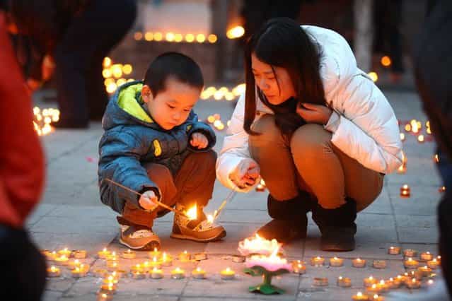 People light candles at Guangren Temple on February 17, 2013 in Xi an, China. The Chinese Lunar New Year of Snake also known as the Spring Festival, which is based on the Lunisolar Chinese calendar, is celebrated from the first day of the first month of the lunar year and ends with Lantern Festival on the Fifteenth day. (Photo by China Foto Press)